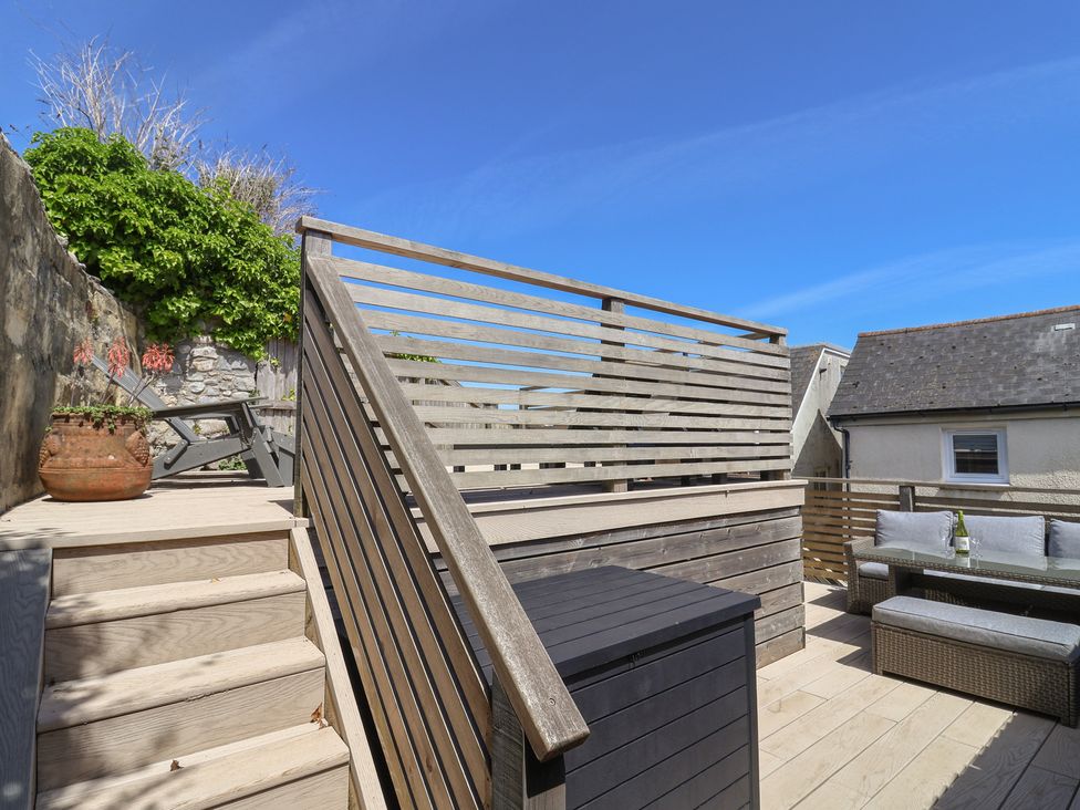 An outdoor area with decking, furniture, and a planter at Avocet in Lyme Regis