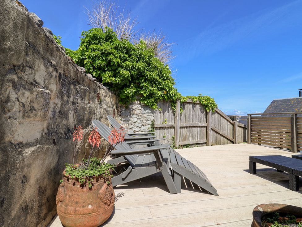 A deck area with chairs and plants at Avocet in Lyme Regis