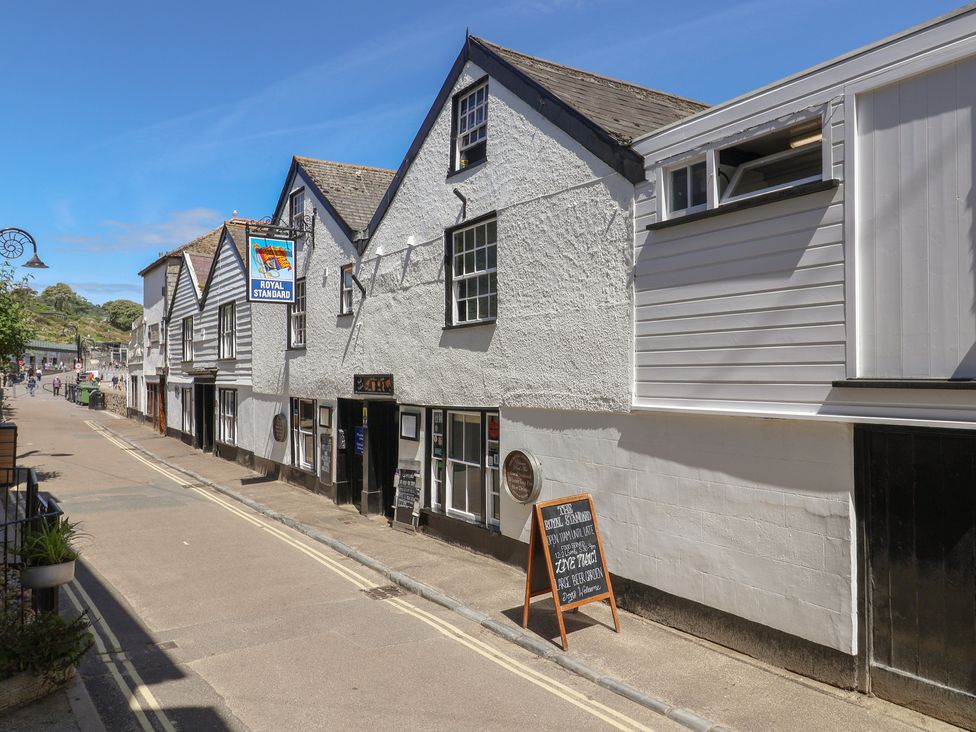 A street view with buildings and a menu board at Avocet Lyme Regis