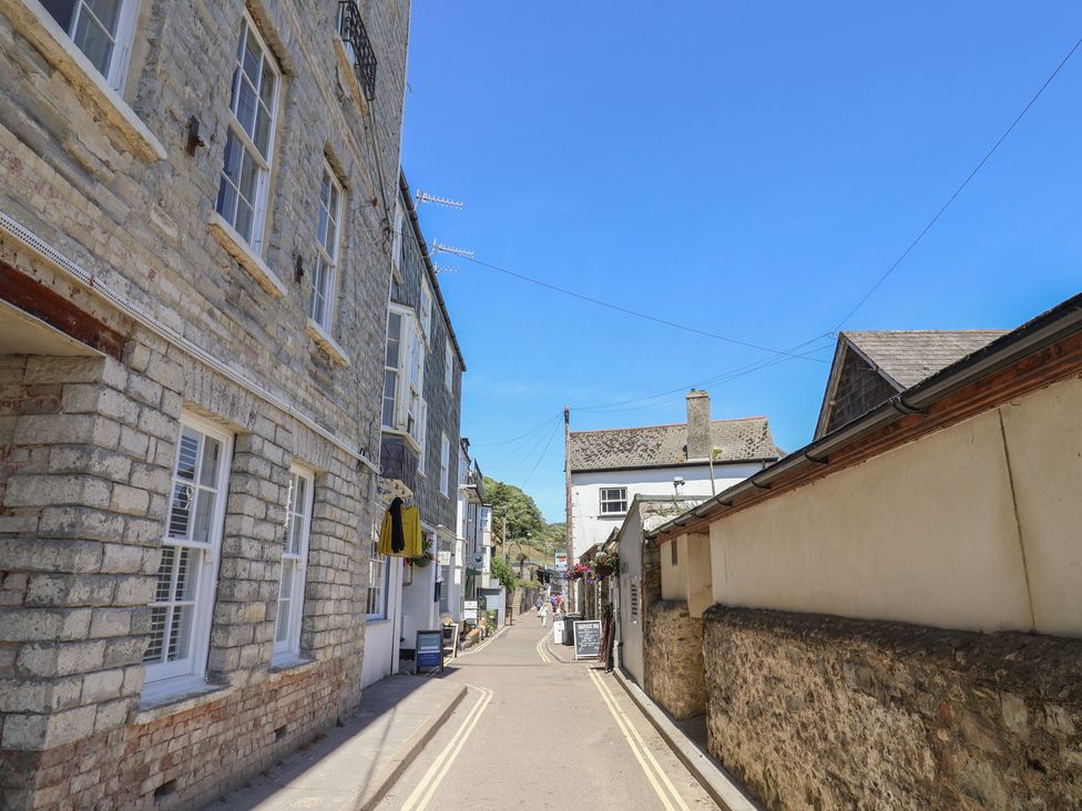 A street view showing stone buildings and a clear sky at Avocet in Lyme Regis