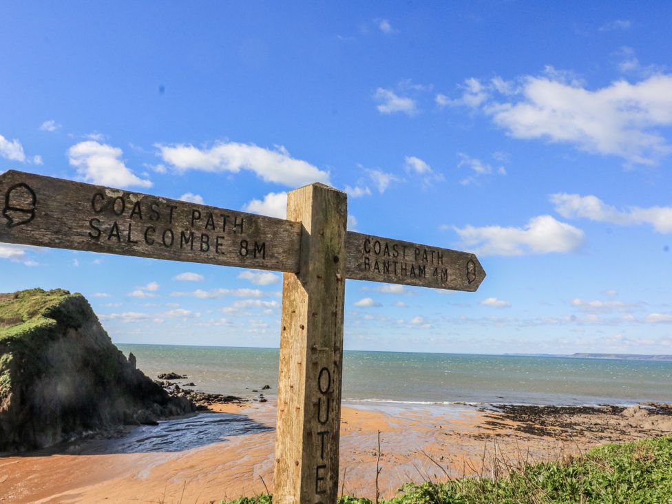A signpost indicating the coast path towards Salcombe and Bantham
