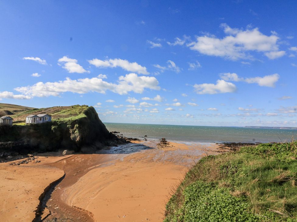 A beach scene with hills and the sea at 3 Brooks Cottages in Hope Cove