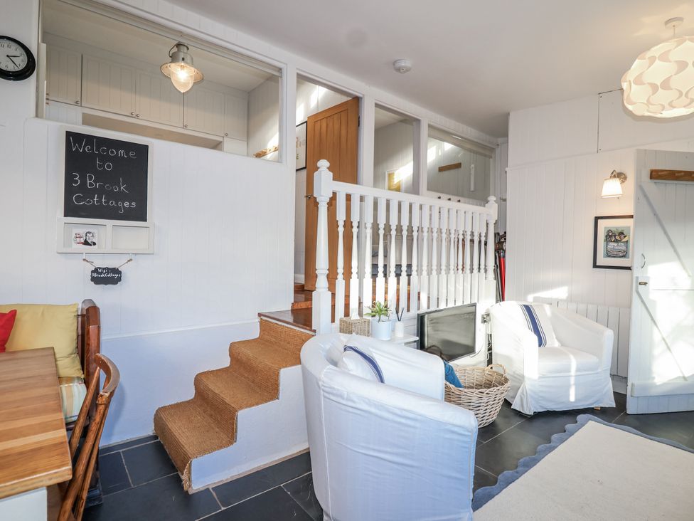 A living room with a dining table and chairs at 3 Brook Cottages in Hope Cove
