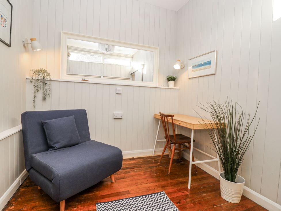 An office with a chair and table at 3 Brook Cottages Hope Cove