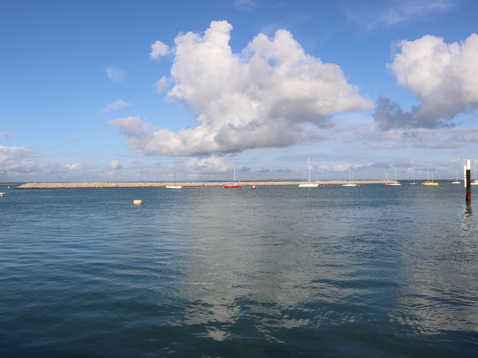 A landscape with boats on water at The Bookshop Apartment in Cowes