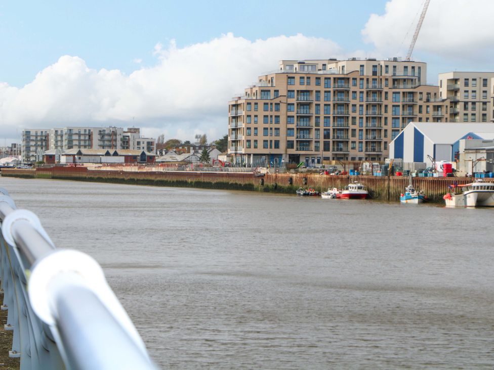 A view of buildings and boats along a river at 67a Harbour Way, Shoreham-by-Sea