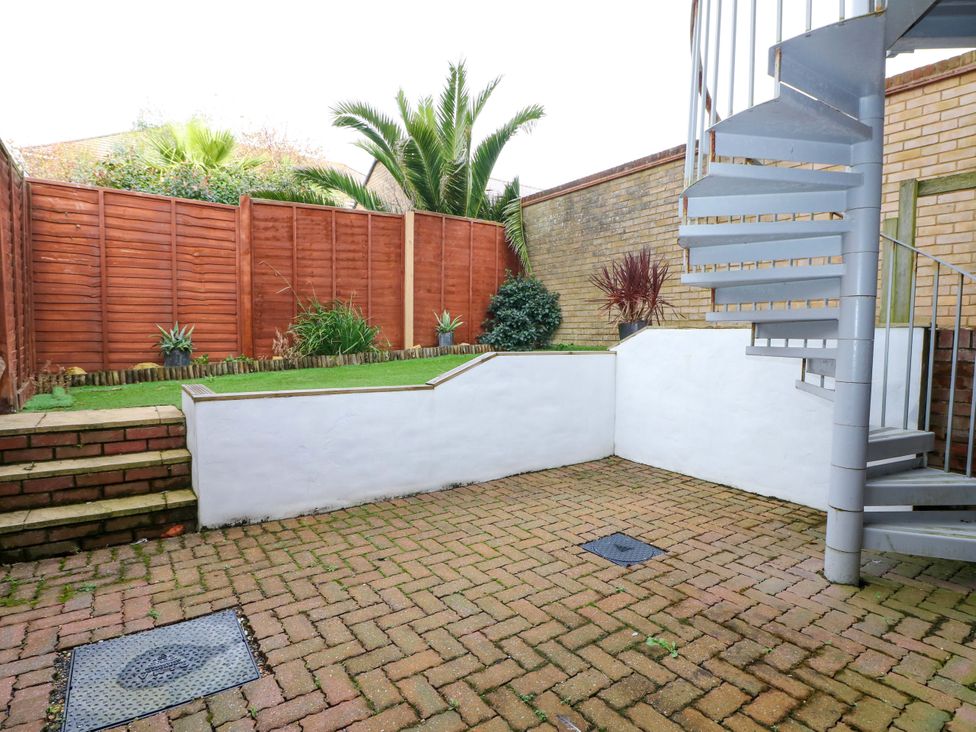 A garden with a spiral staircase and paving stones at 67a Harbour Way Shoreham-by-Sea