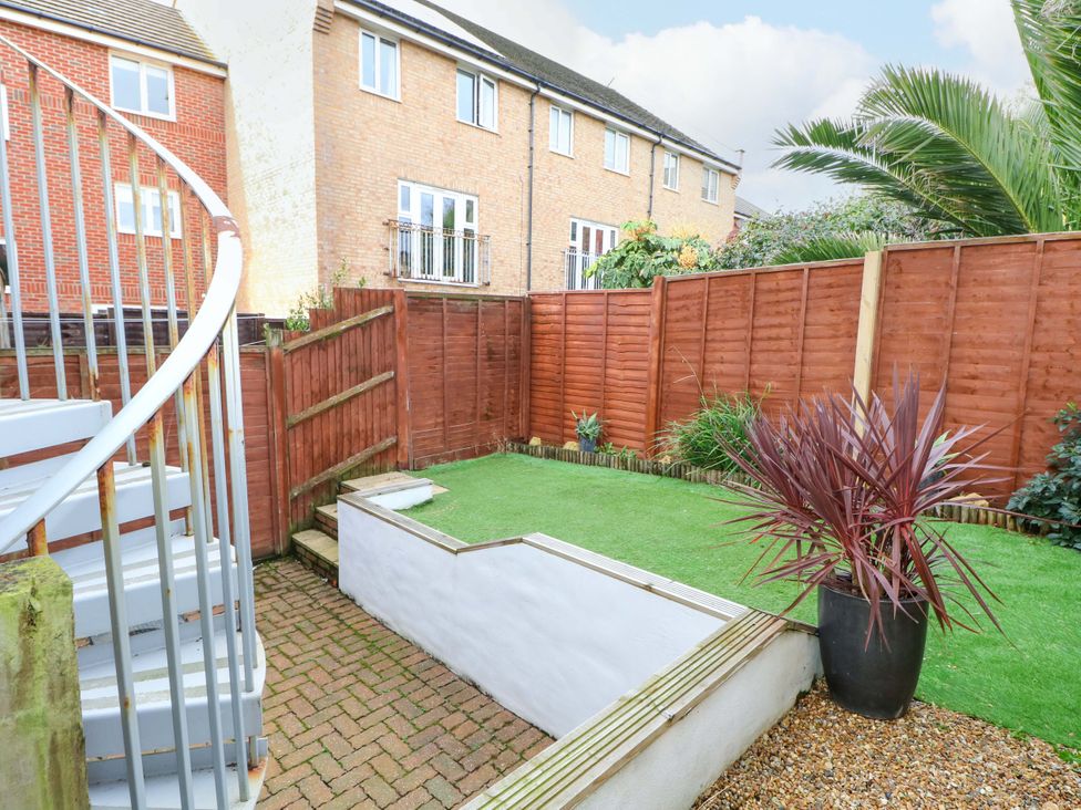 A garden with a spiral staircase and a gravel area at 67a Harbour Way Shoreham-by-Sea