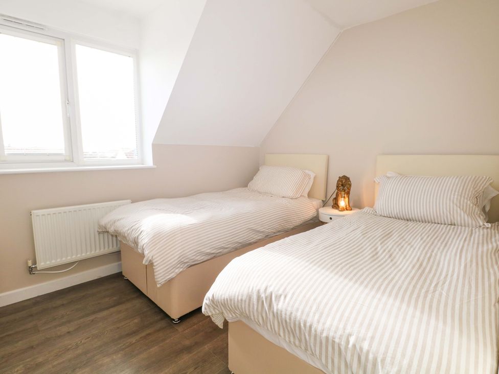 A bedroom with two beds and a window at 67a Harbour Way Shoreham-by-Sea