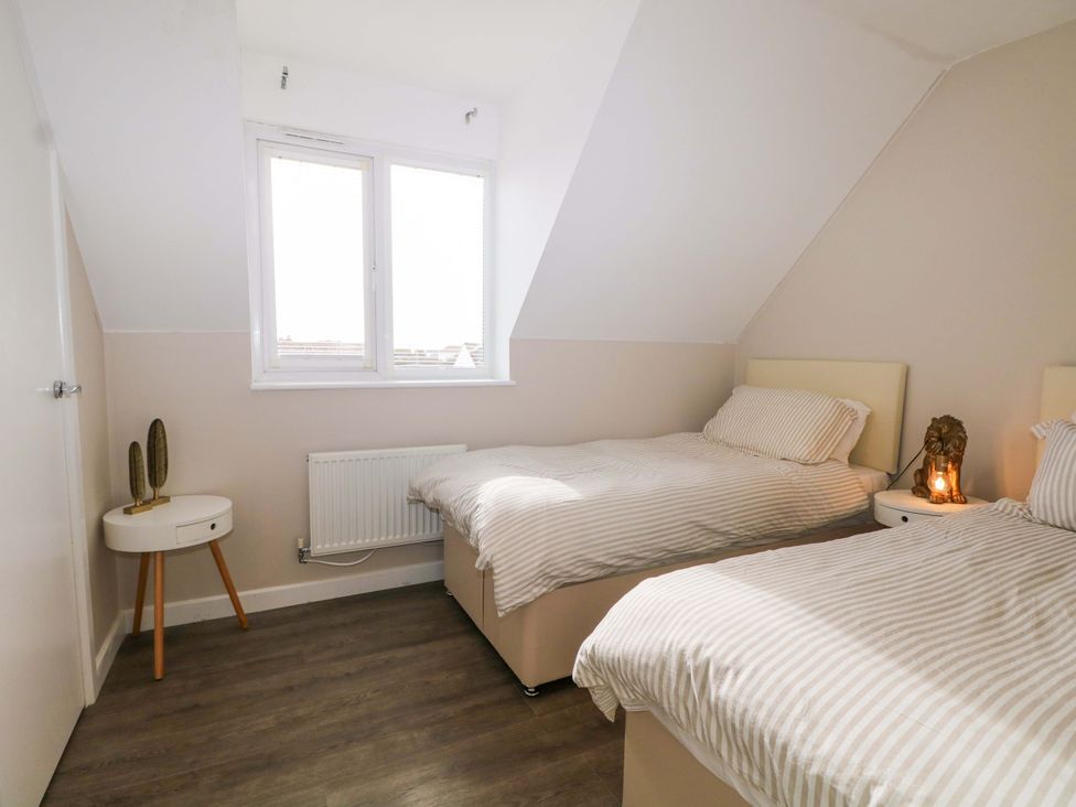 A bedroom with twin beds and a window at 67a Harbour Way Shoreham-by-Sea