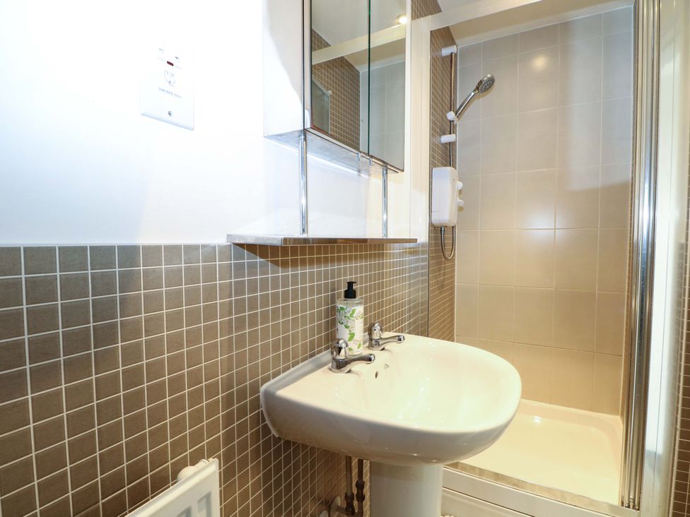 A bathroom with a sink and shower at 67a Harbour Way Shoreham-by-Sea