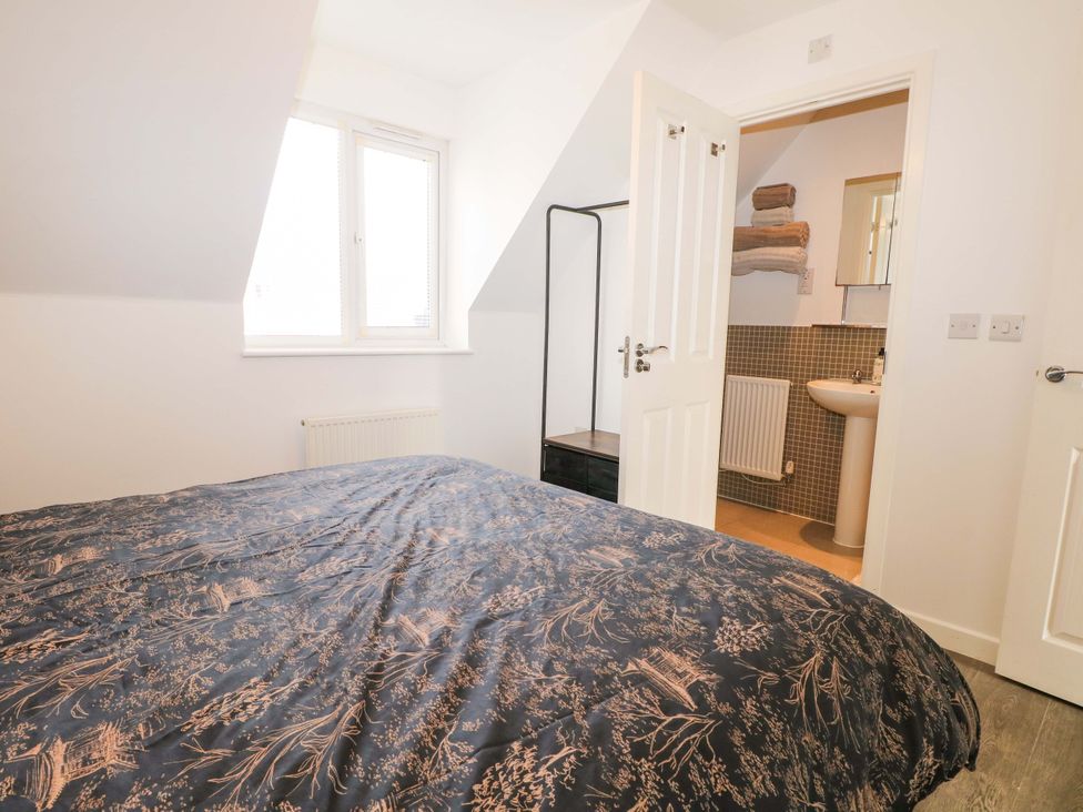 A bedroom with a bed and en-suite bathroom at 67a Harbour Way Shoreham-by-Sea