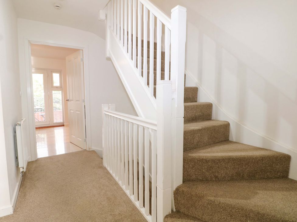 A hallway with stairs and a door at 67a Harbour Way Shoreham-by-Sea