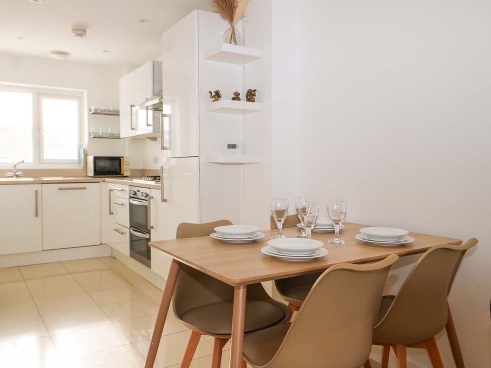 A kitchen with a dining table and chairs at 67a Harbour Way Shoreham-by-Sea
