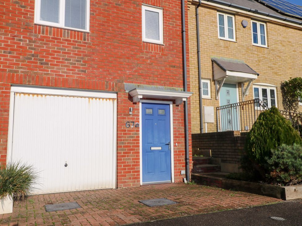 A house exterior with a blue front door and garage at Harbour Way Shoreham-By-Sea