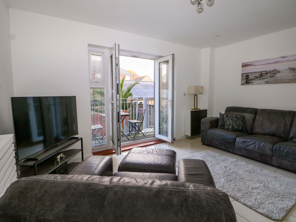 A living room with a TV and sofa at Harbour Way in Shoreham-By-Sea