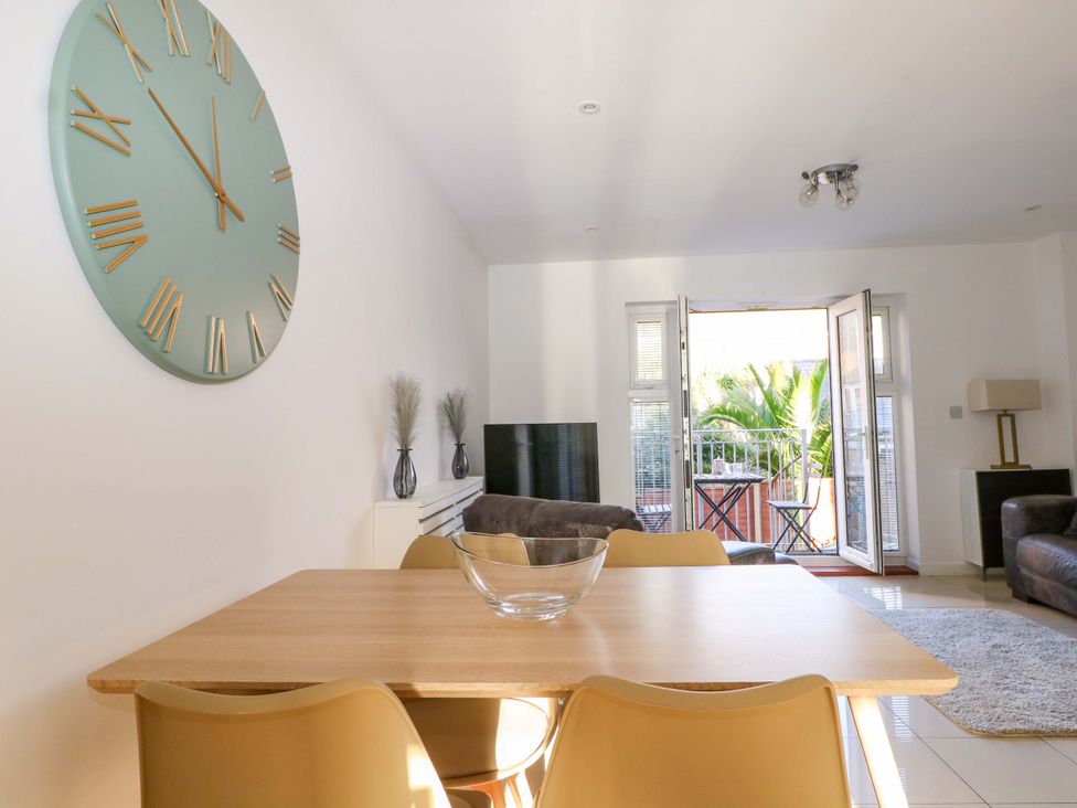 A dining room with a table and chairs at Harbour Way in Shoreham-By-Sea