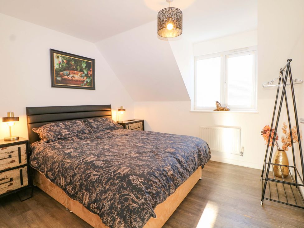 A bedroom with a bed and nightstands at Harbour Way in Shoreham-By-Sea