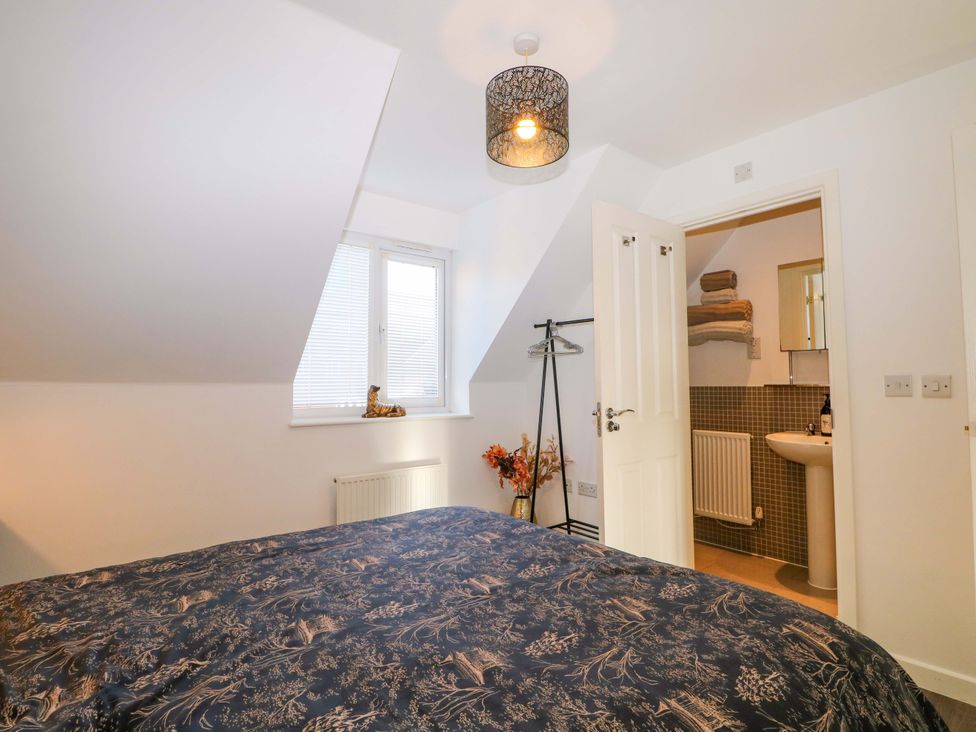 A bedroom with a bed and an en-suite bathroom at Harbour Way in Shoreham-By-Sea