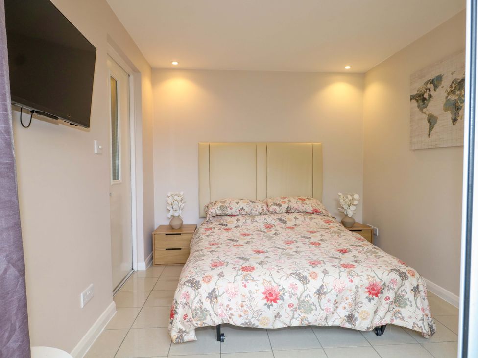 A bedroom with a bed and television at Harbour Way in Shoreham-By-Sea