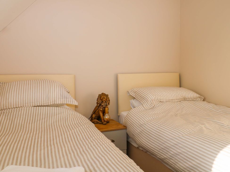 A bedroom with two beds and a lion statue at Harbour Way in Shoreham-By-Sea