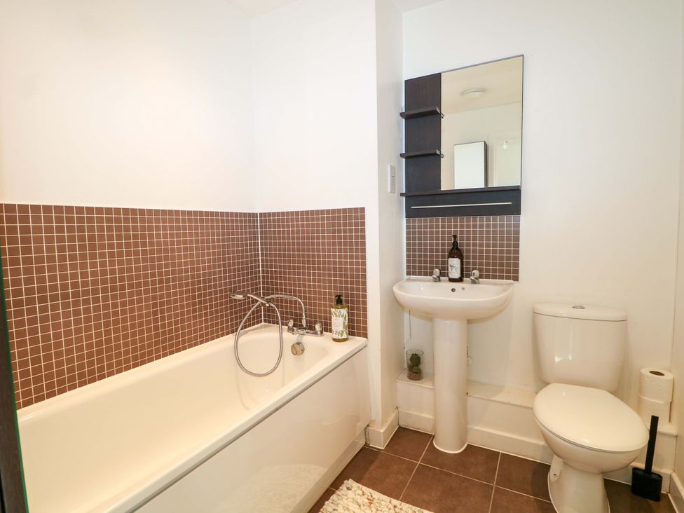 A bathroom with a bathtub, sink, and toilet at Harbour Way in Shoreham-By-Sea