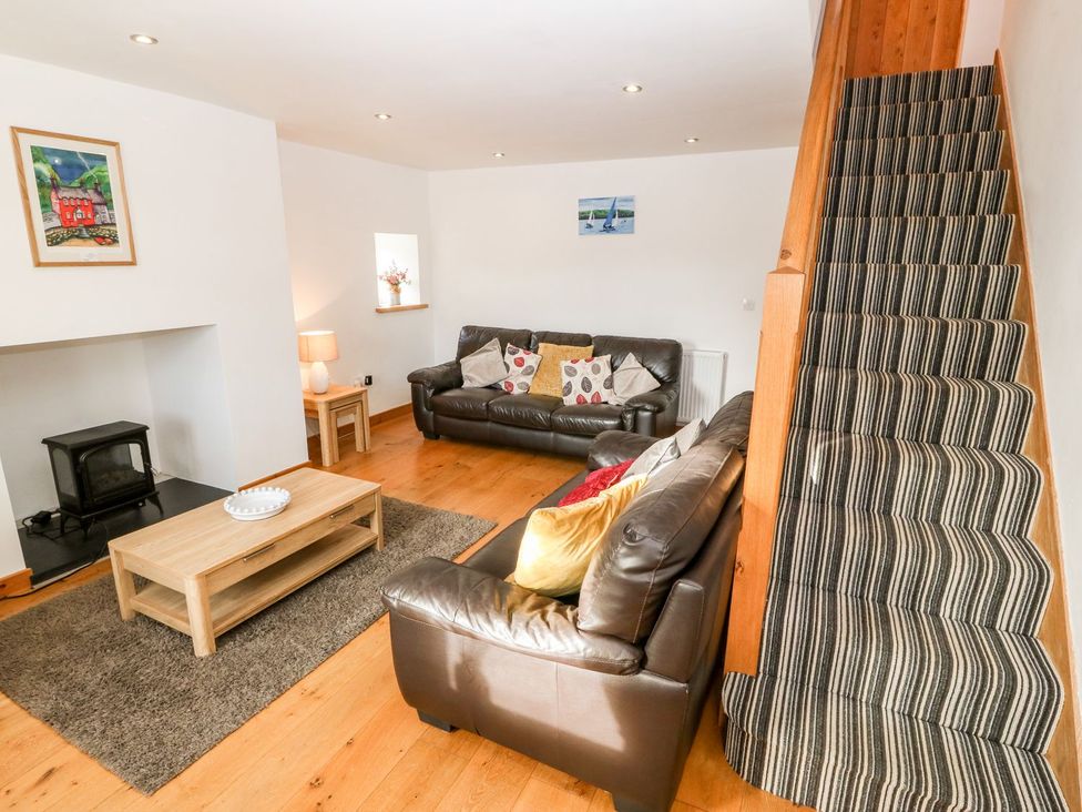 A living room with couches and a coffee table at The Old Barn in Pwllheli