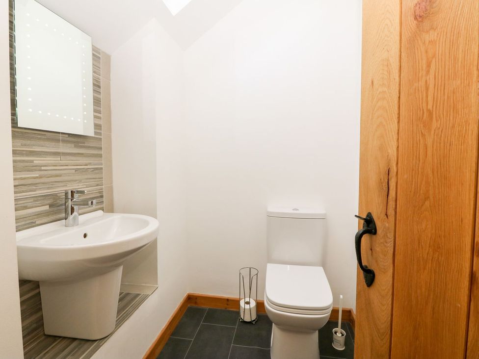 A bathroom with a sink and toilet at The Old Barn in Pwllheli