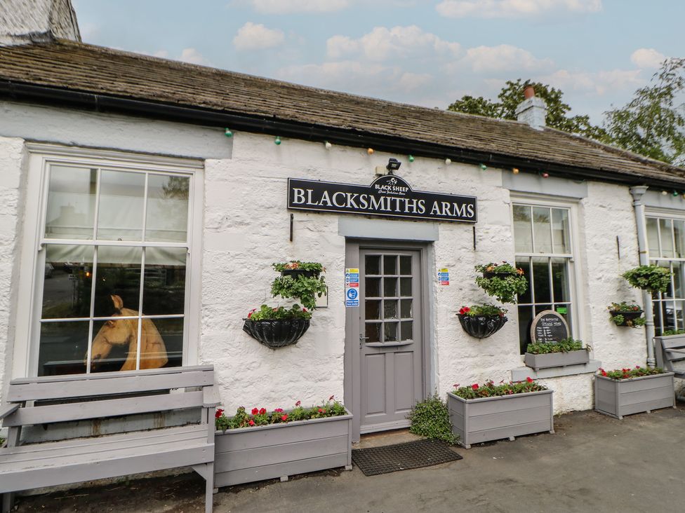 A building with a sign and flower planters at Blacksmiths Arms in Barnard Castle