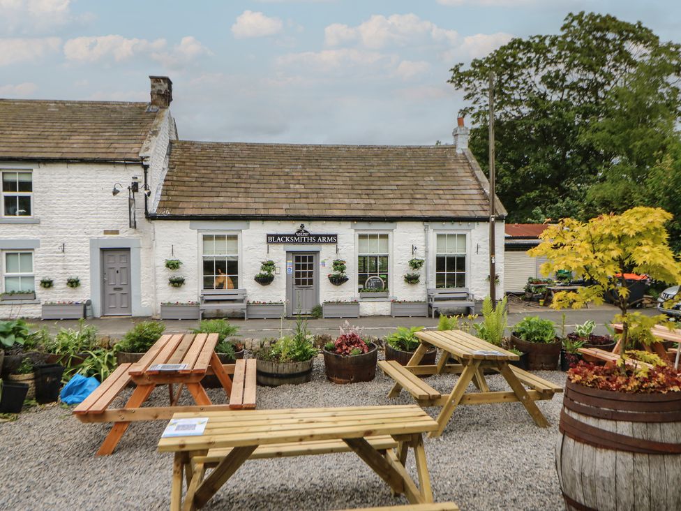 An outdoor area with tables and flowerpots at Blacksmiths Arms in Barnard Castle