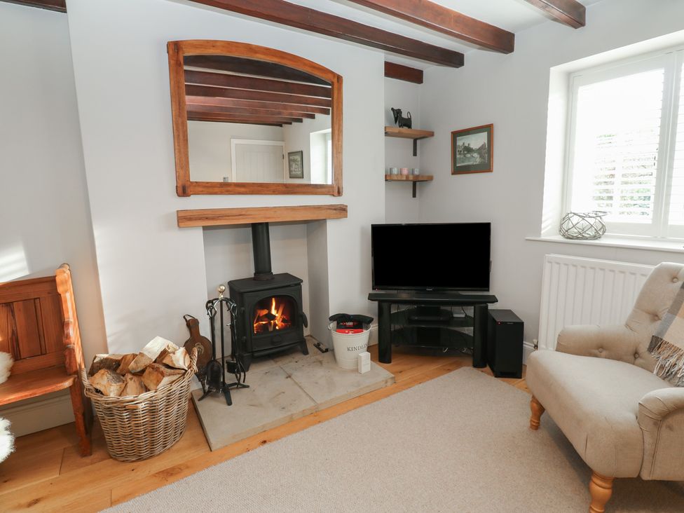 A living room with a fireplace and television at Daleholme in Mickleton, Teesdale