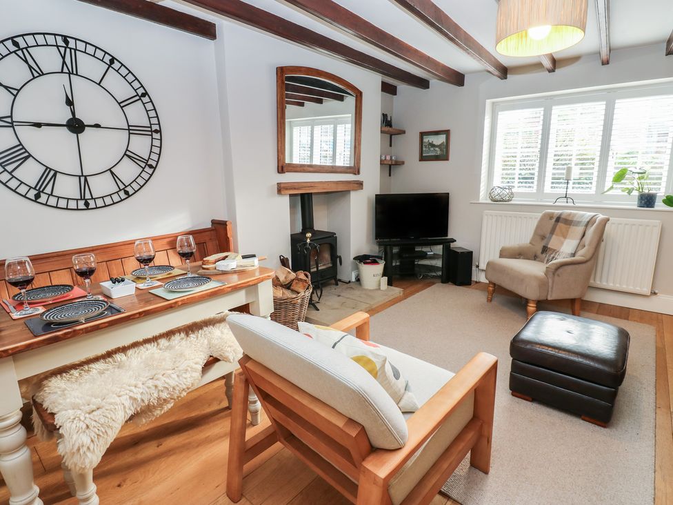 A living room with a dining table and armchair at Daleholme, Mickleton, Teesdale