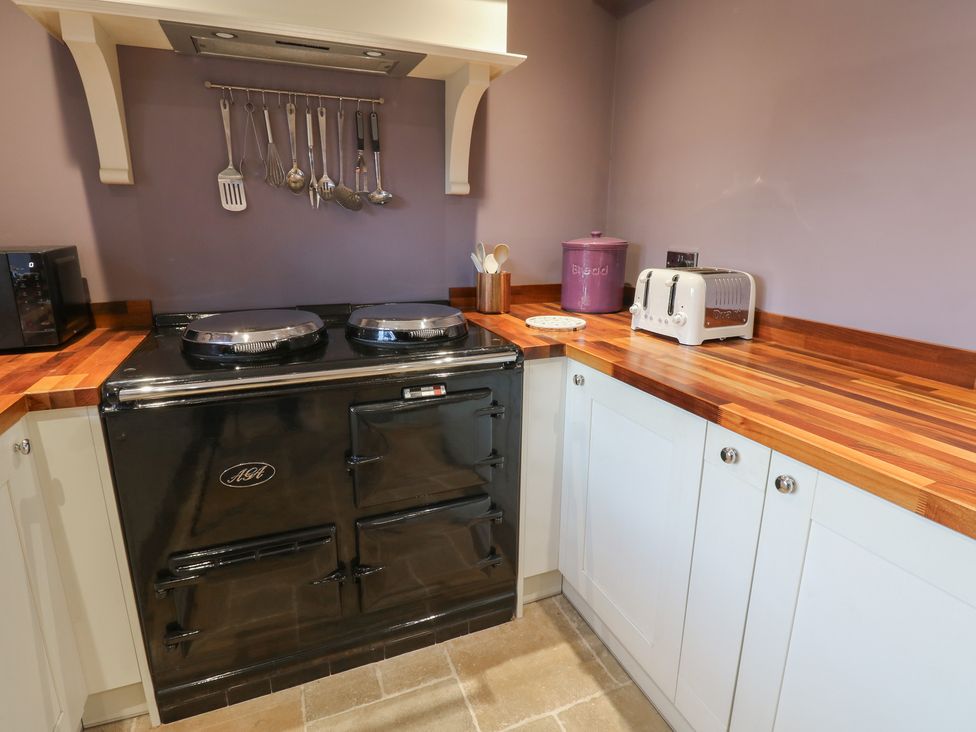A kitchen with a black stove and countertop at Daleholme, Mickleton, Teesdale
