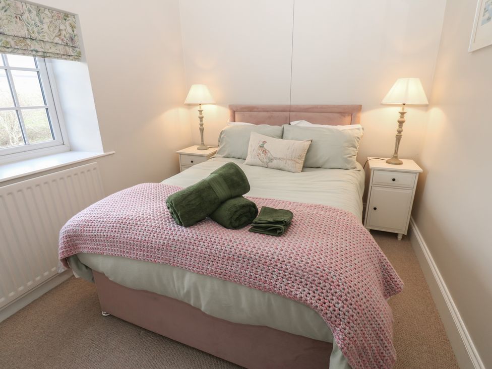 A bedroom with a bed and nightstands at Daleholme in Mickleton, Teesdale