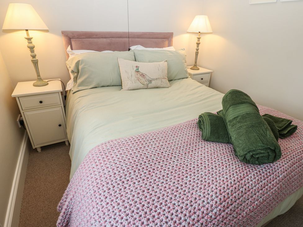 A bedroom with a bed and nightstands at Daleholme in Mickleton, Teesdale