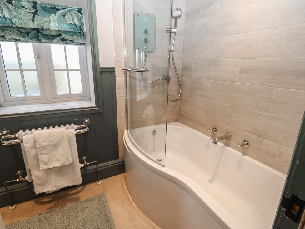 A bathroom with a bathtub and shower at Daleholme in Mickleton, Teesdale