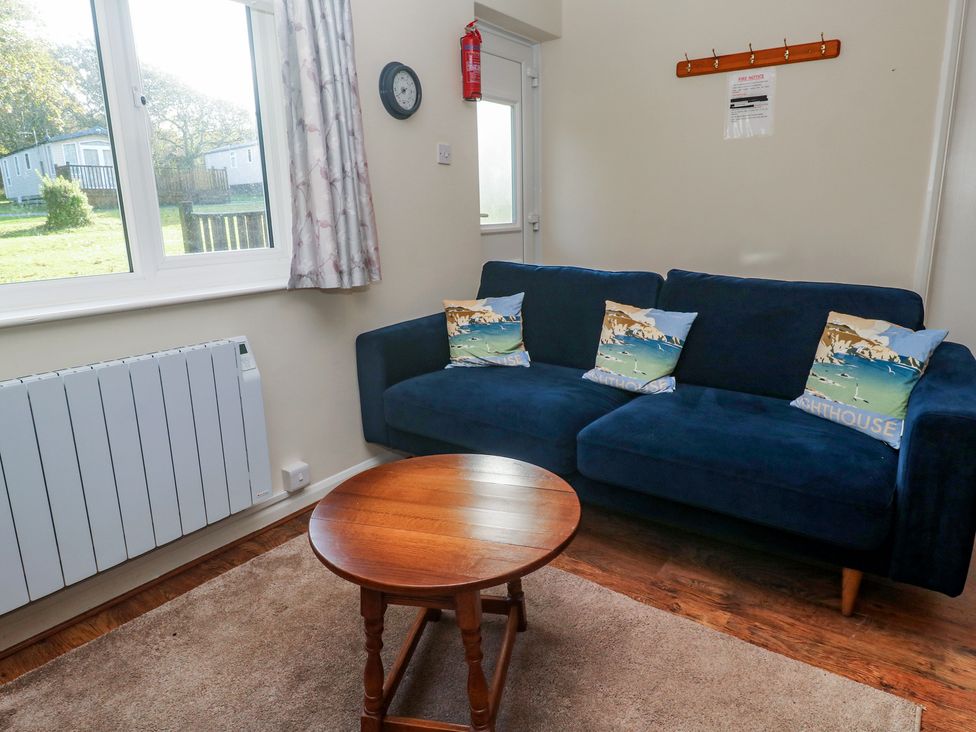 A living room with a sofa and coffee table at Little Egret - Number 2