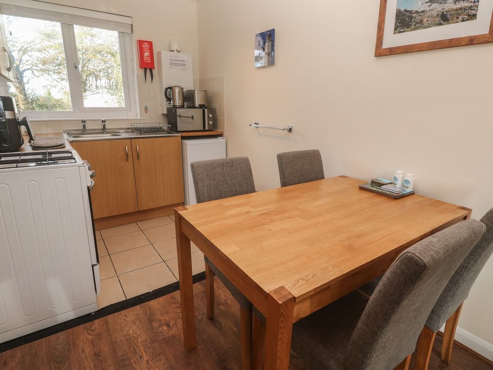 A kitchen with a dining table and chairs at Little Egret - Number 2