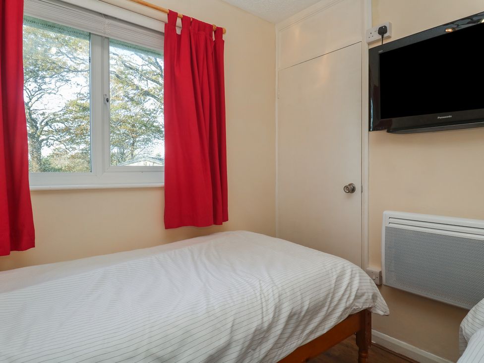 A bedroom with a bed and a TV at Little Egret - Number 2