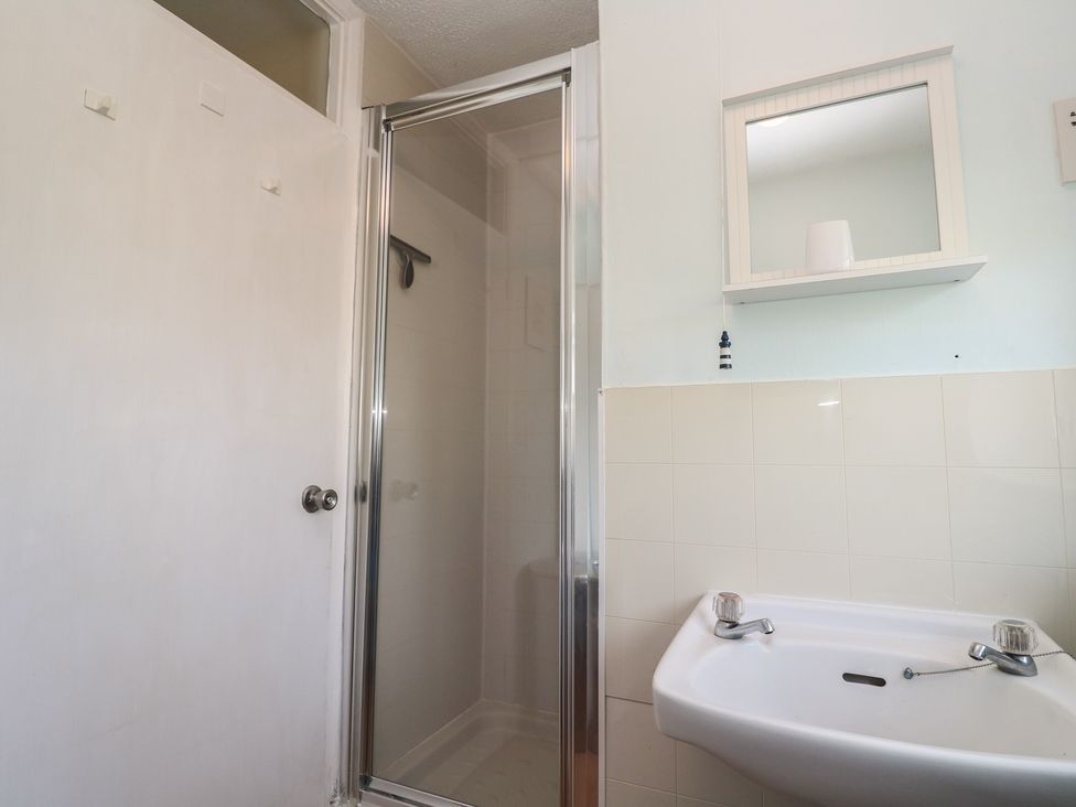 A bathroom with a shower and sink at Little Egret - Number 2