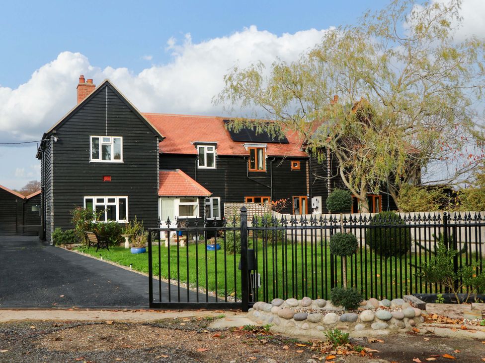 A house with a garden and fence at 7 Oaks Track in Carshalton