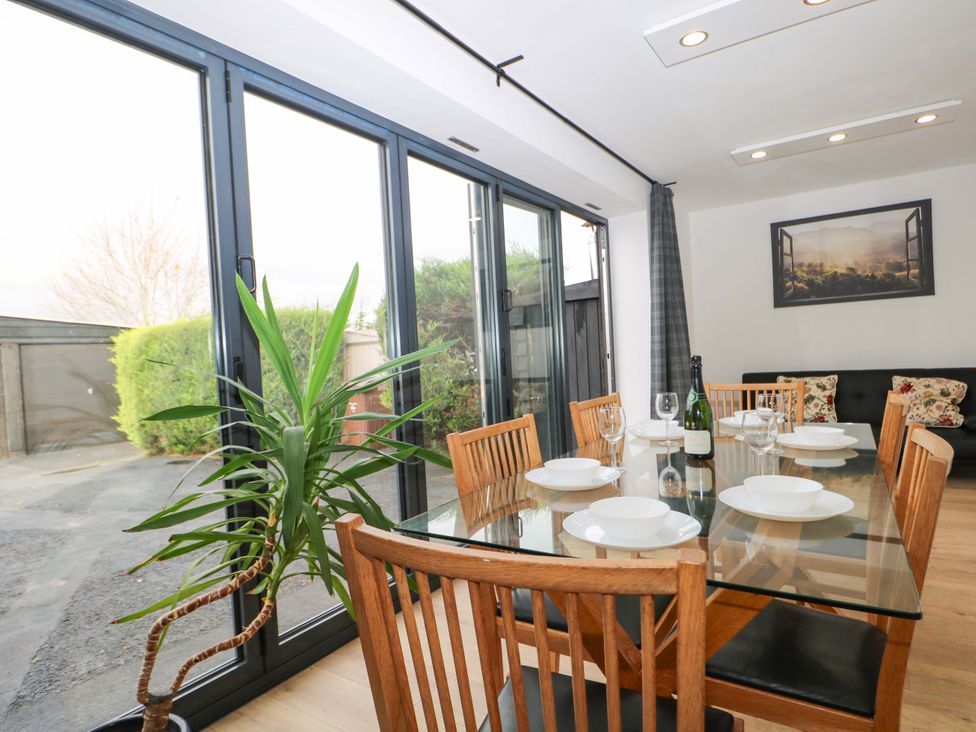 A dining room with a table and chairs at 7 Oaks Track in Carshalton