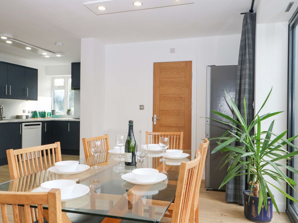 A dining room with a table and chairs at 7 Oaks Track in Carshalton