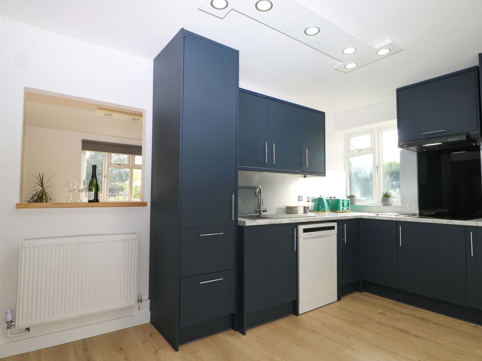 A kitchen with modern cabinets and appliances at 7 Oaks Track in Carshalton