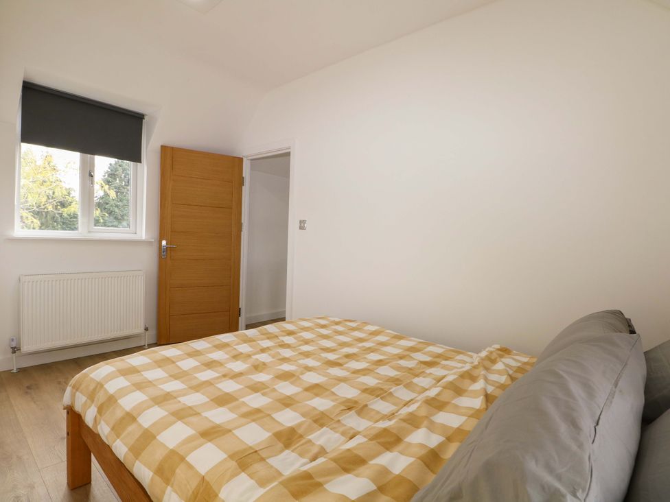 A bedroom with a bed and window at 7 Oaks Track in Carshalton