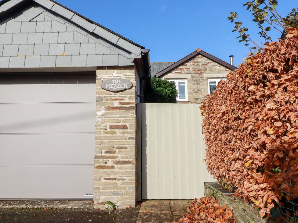 The exterior of a property with a garage and a gate at The Mizzen in St Endellion near Port Isaac
