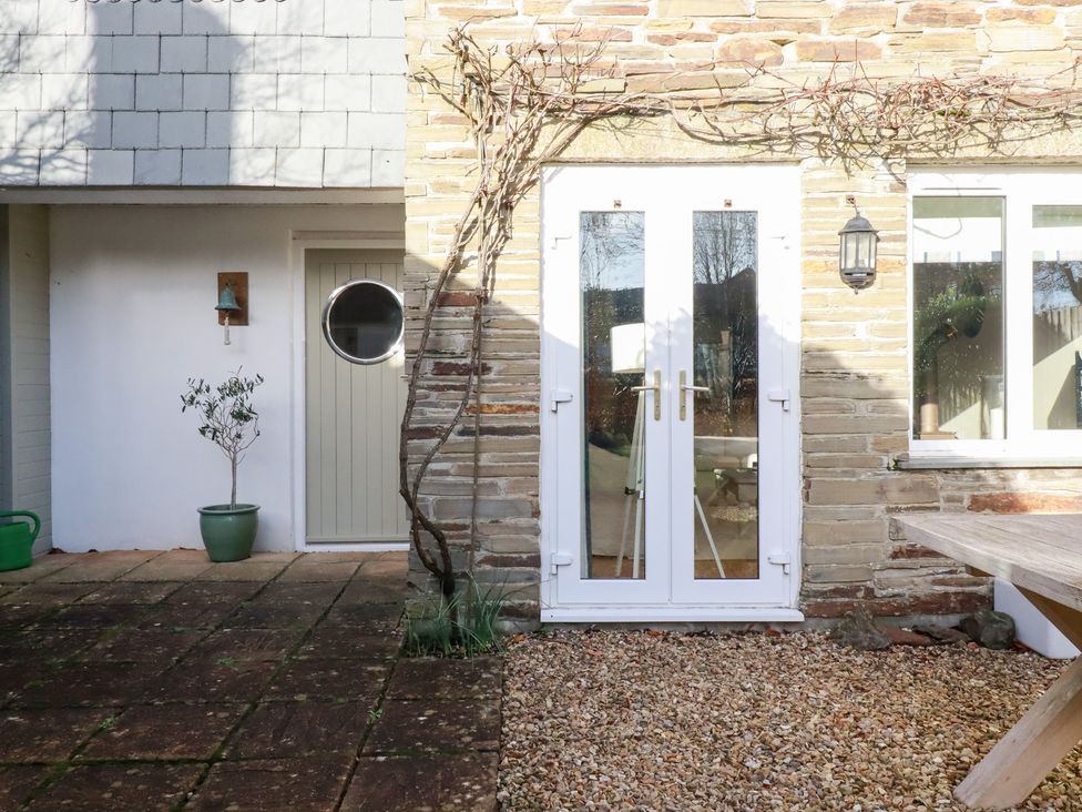 An outdoor area featuring a door, window, and potted plant at The Mizzen in St Endellion near Port Isaac