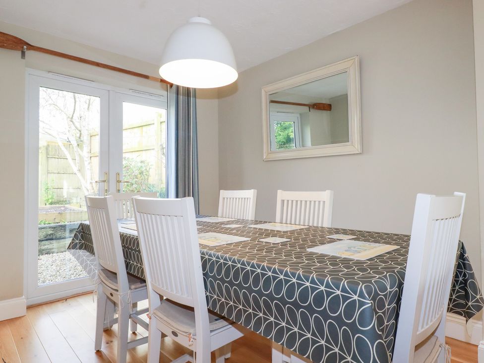 A dining room with a table and chairs at The Mizzen in St Endellion near Port Isaac