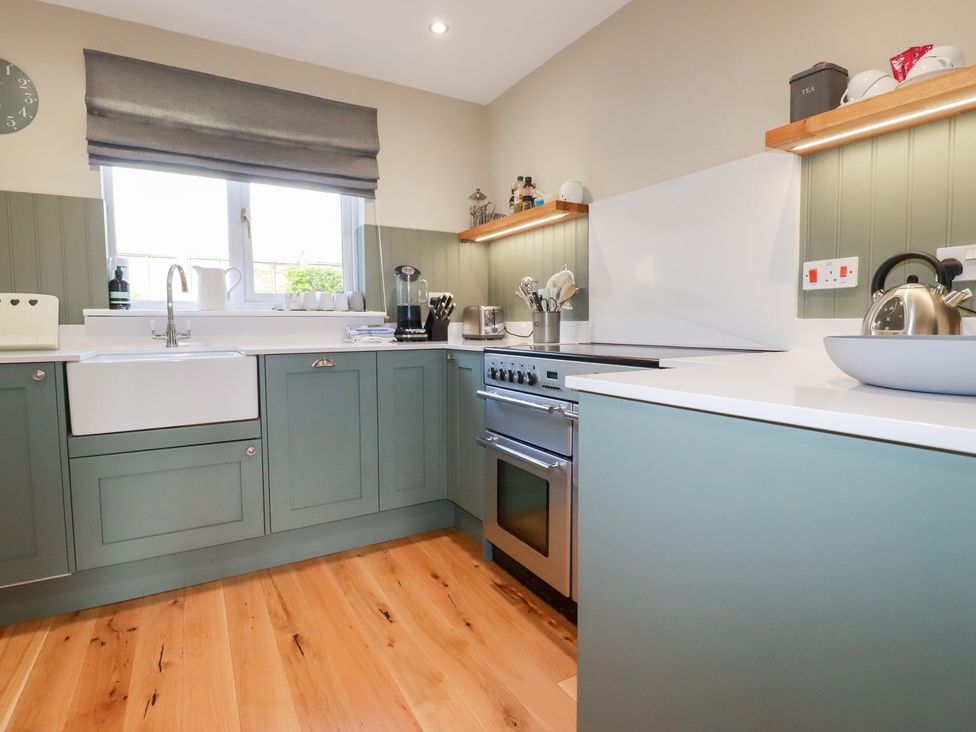 A kitchen with a sink and oven at The Mizzen St Endellion near Port Isaac
