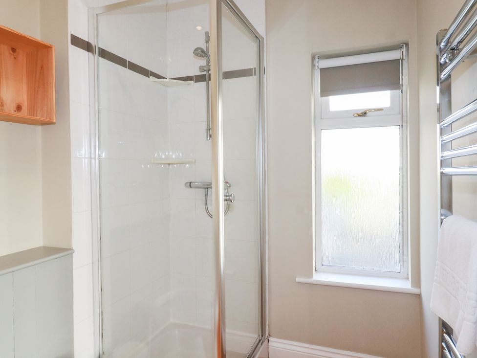 A shower and towel rail in the bathroom at The Mizzen St Endellion near Port Isaac